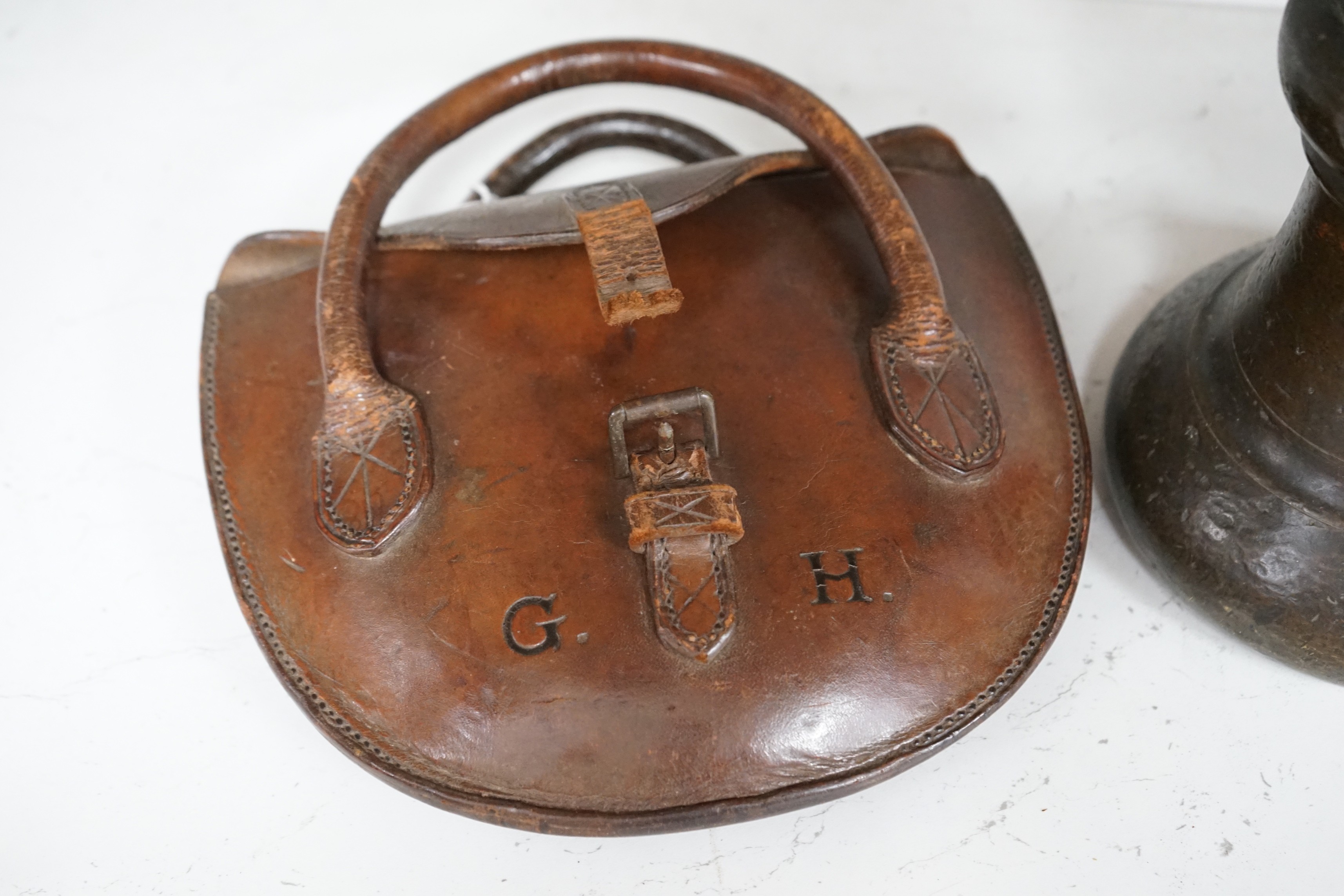 A single Victorian inscribed weight, together with quoits in brown leather case initialled G.H.